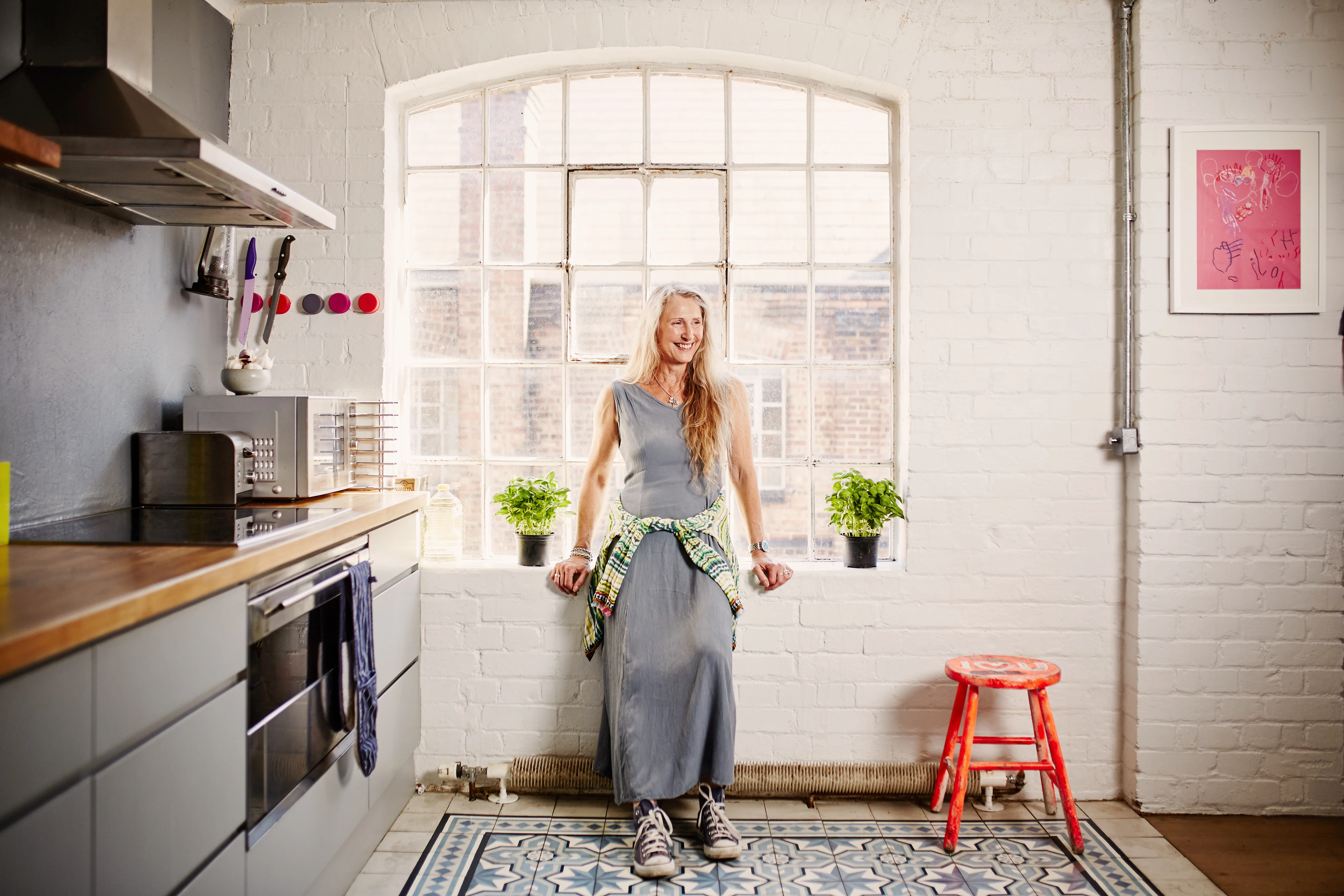 woman in gray dress in her kitchen