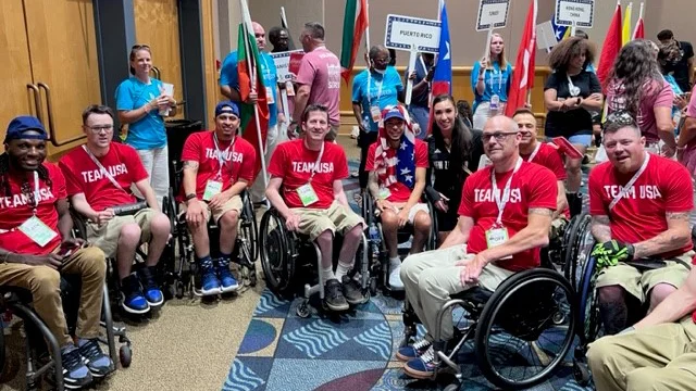 a group of people sitting in wheelchairs