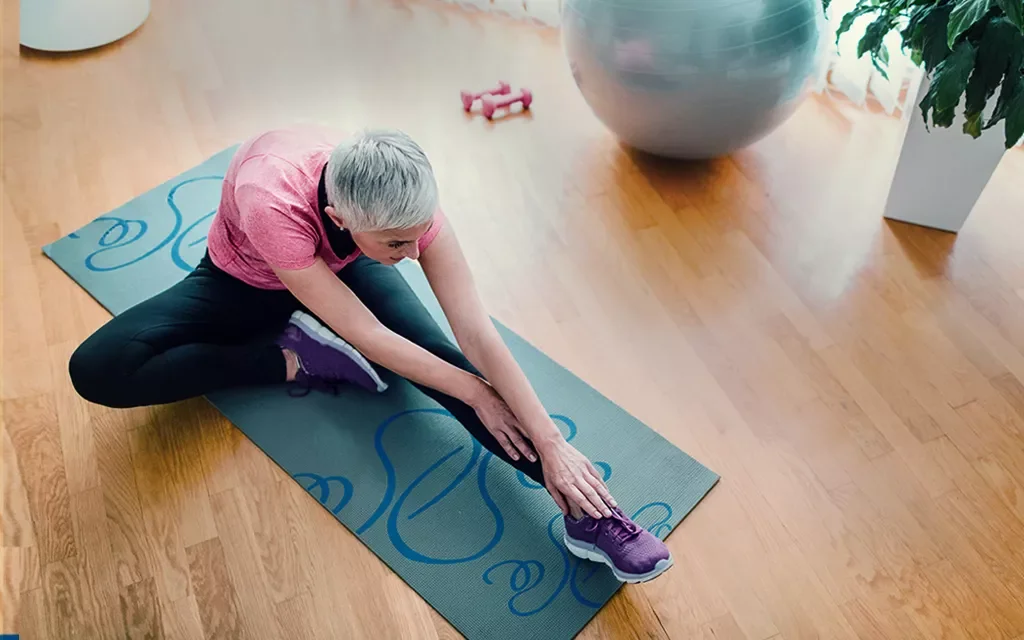 a person sitting on a blue mat
