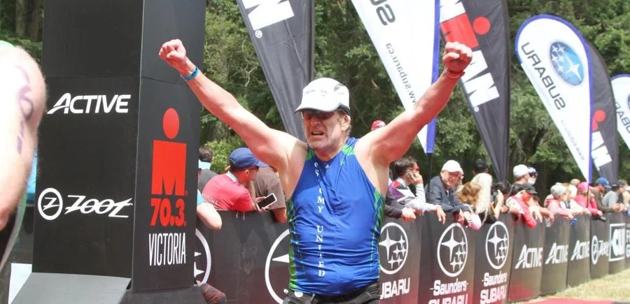 Ted Vosk crossing a marathon finish line